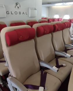 Airplane seats with Global Airlines headrests.