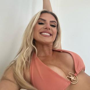Woman in coral bikini top smiling.