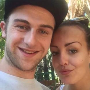 Photo of a man and woman smiling for a selfie.