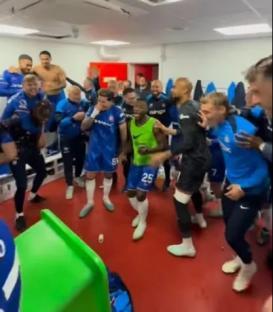 Soccer team celebrating in locker room.