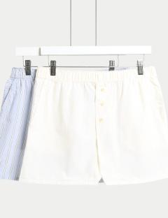 Two pairs of striped cotton pajama shorts hanging on a white hanger.
