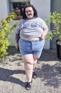 Photo of Beckie Bold wearing a gray Arkansas t-shirt and denim shorts.