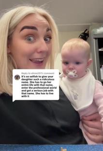 Woman holding baby, responding to comment about baby's name.