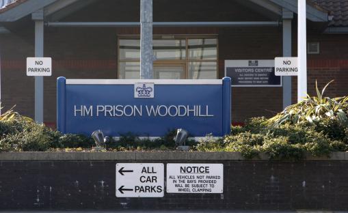 HM Prison Woodhill entrance sign and parking instructions.