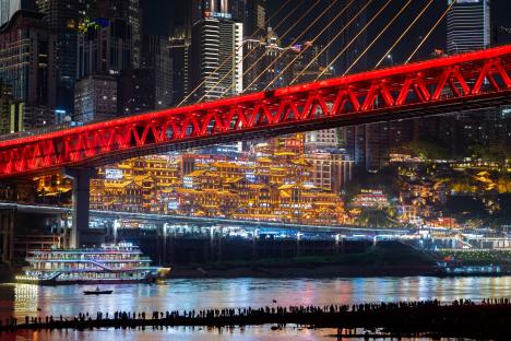 CHONGQING, CHINA - APRIL 30: Tourists visit Jiangbeizui Jiangtan Park under Qiansimen Jialing River Bridge ahead of the May Day holiday on April 30, 2025 in Chongqing, China. The five-day May Day holiday will start on May 1 this year. (Photo by Fuyu Jianglin/VCG via Getty Images)