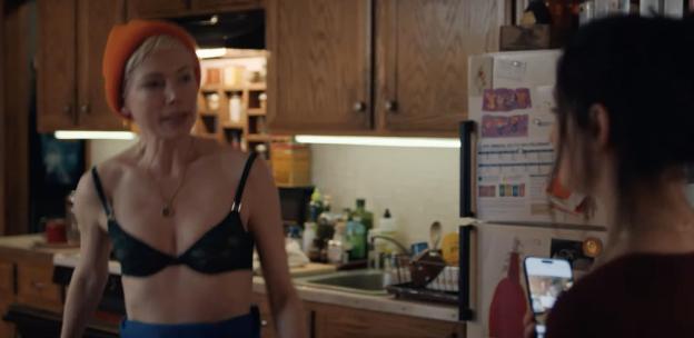 Still image from the FX series *Dying for Sex*, showing Michelle Williams and Jenny Slate in a kitchen.