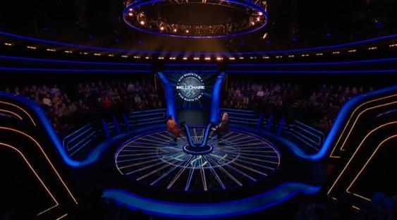 Who Wants to Be a Millionaire? set with contestant and host.