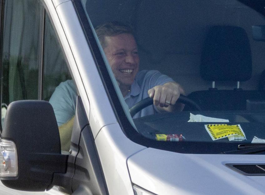 Tom Skinner driving a van with a parking ticket on the dashboard and his wedding ring on his finger.