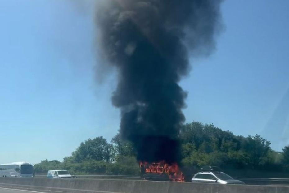 Flames tear through minibus on major A-road as terrified travellers clutching suitcases left stranded