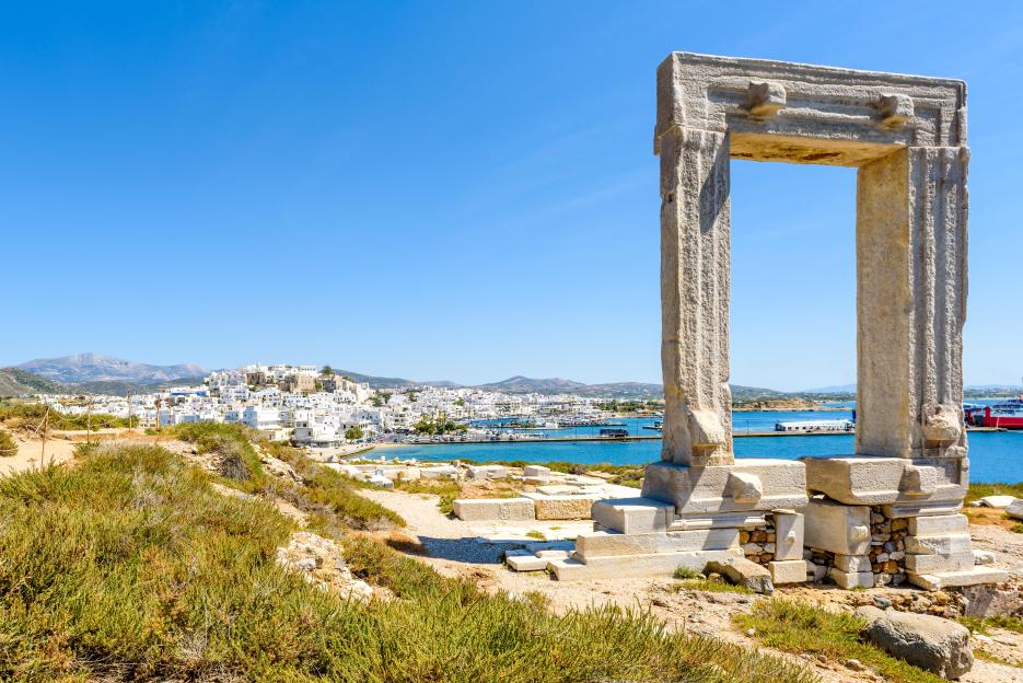 The Portara of Naxos, Greece, with Naxos town in the background.