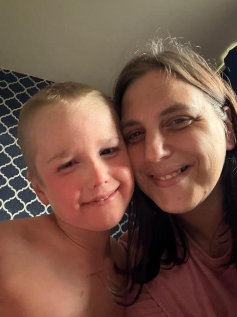 Leeanna and her son Caiden smile as they pose for a close-up selfie.