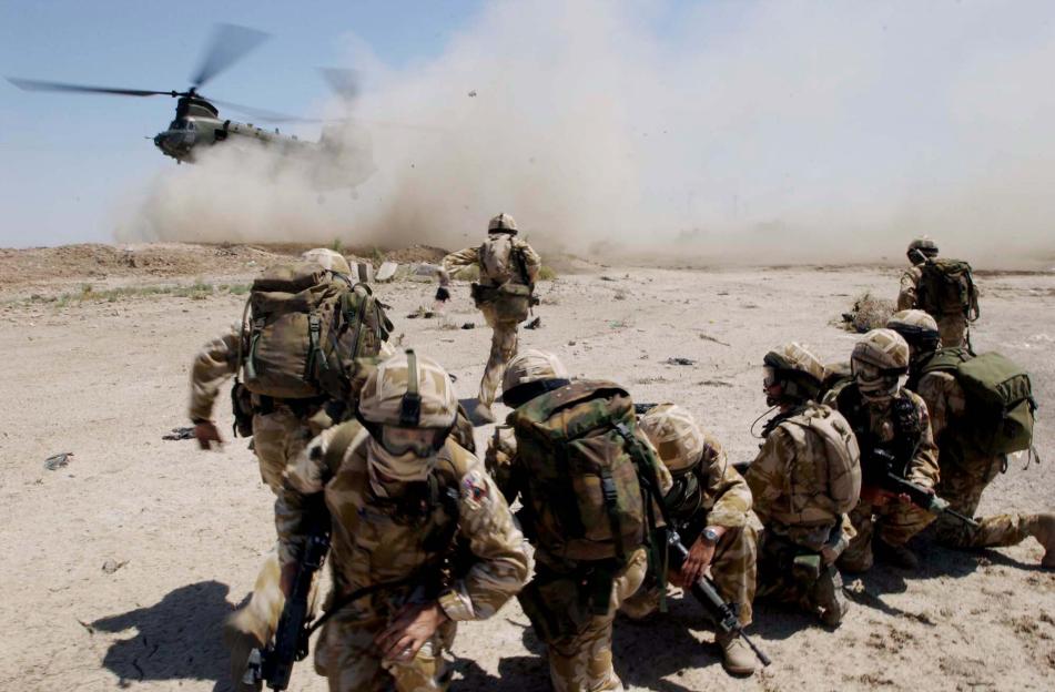 British soldiers deploying from a Chinook helicopter during a vehicle checkpoint in Basra, Iraq.