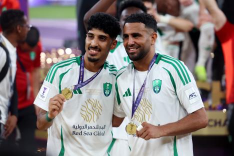Ziyad Al-Johani and Riyad Mahrez holding their medals after an Al-Ahli victory.