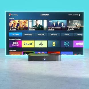 Freeview TV box with on-screen menu showing various channels and apps.