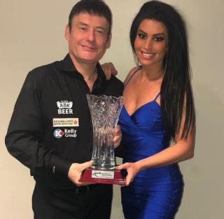 Jimmy White and Jade holding an award.