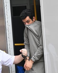 Alireza Askari, handcuffed, appearing in court.