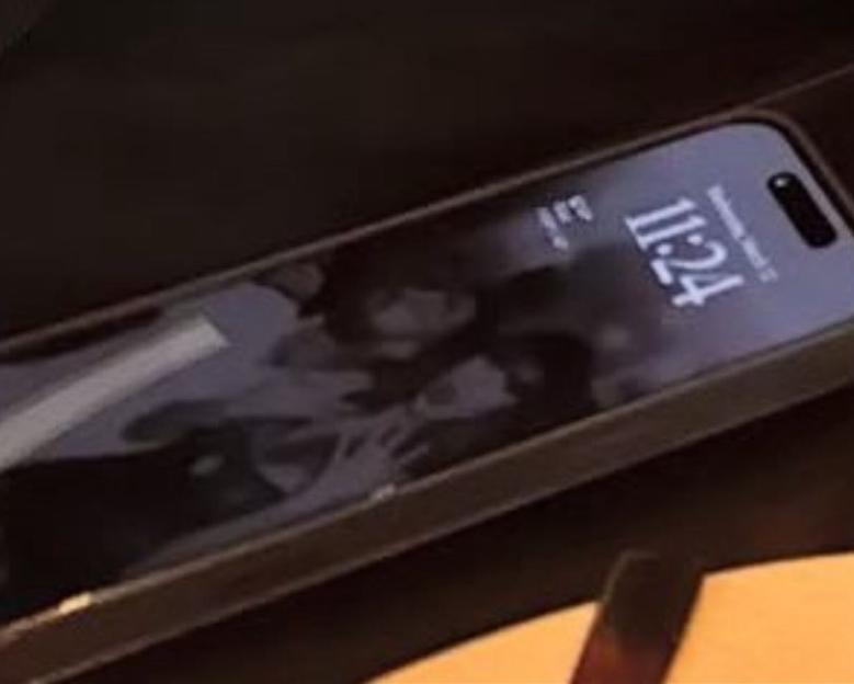 Phone displaying a photo of two people.