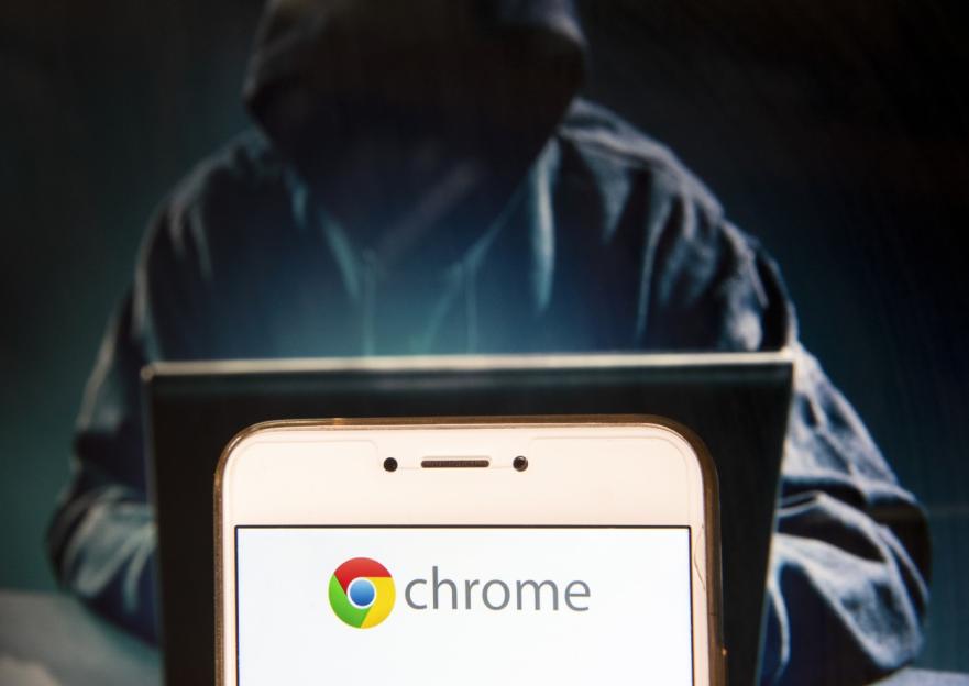 HONG KONG - 2018/11/23: In this photo illustration, the American web browser developed by Google, Chrome,logo is seen displayed on an Android mobile device with a figure of hacker in the background. (Photo Illustration by Miguel Candela/SOPA Images/LightRocket via Getty Images)