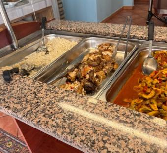 Hotel buffet with rice, chicken, and vegetables.