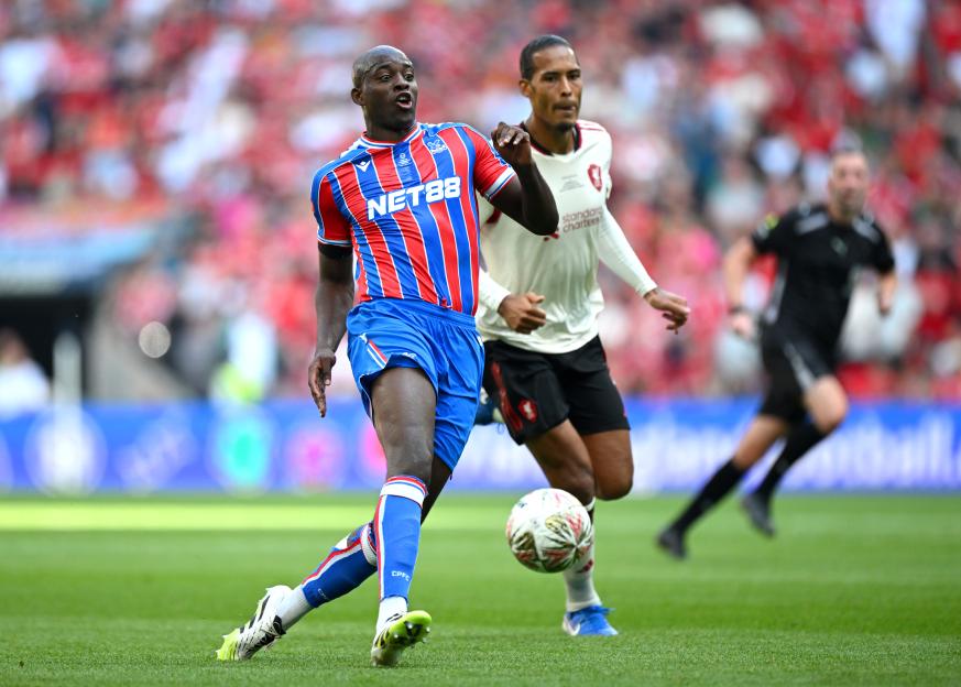 Jean-Philippe Mateta of Crystal Palace dribbling the ball during a soccer match.