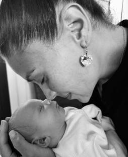 Black and white photo of a mother and her newborn baby.