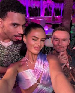 Olivia Hawkins with two men in Ibiza.