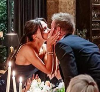 The Beckham family at a dinner party, kissing.