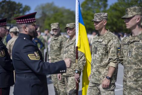Military personnel in uniform rehearsing for a parade.