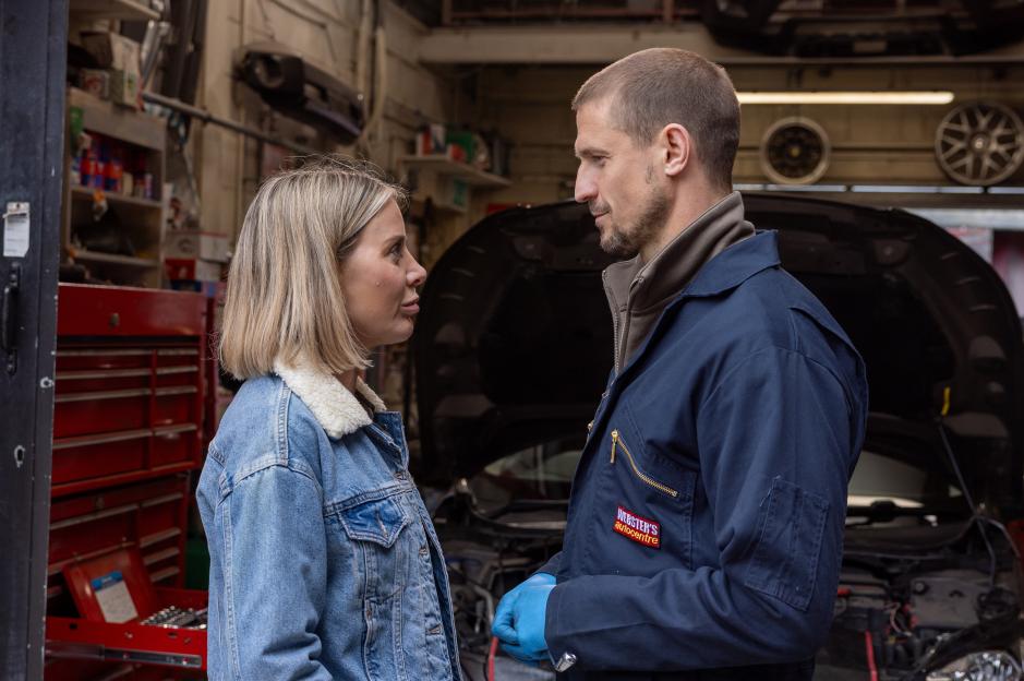 Abi Webster and Carl Webster in an auto repair shop.