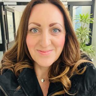 Photo of a woman with long brown hair.