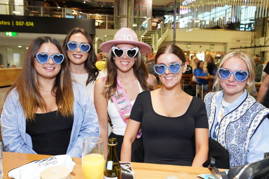 Group of women celebrating a 30th birthday at a pub.