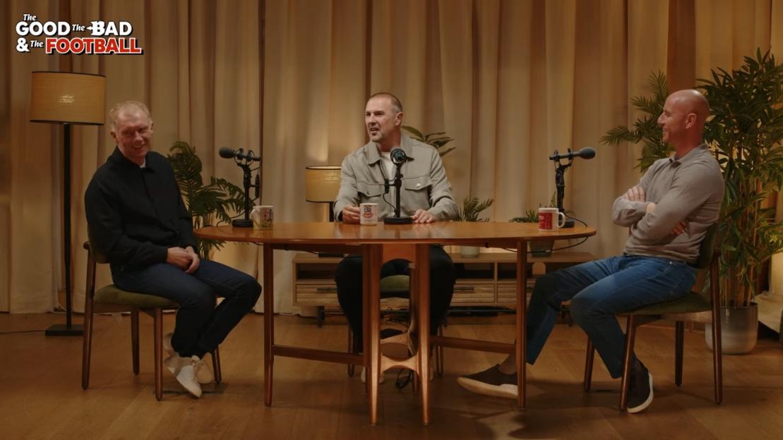 Three men sit around a table with microphones for a podcast recording.