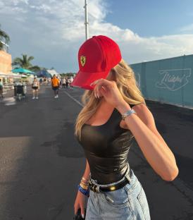 Woman at F1 wearing a Ferrari hat.