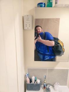 Mirror selfie of a darts player working as a plumber.