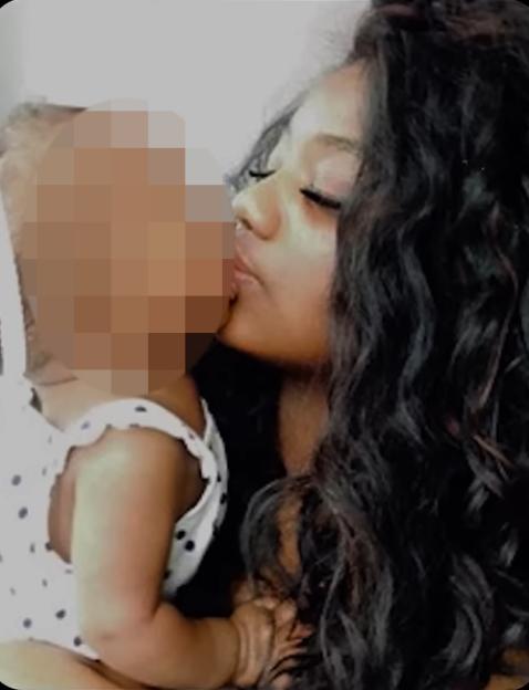 Woman kissing a baby.
