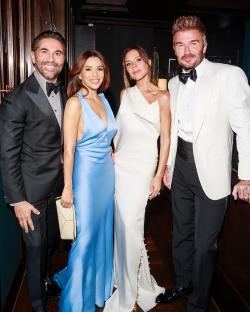 Victoria and David Beckham with friends at a celebration.