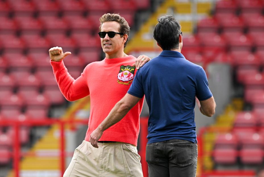 Ryan Reynolds and Rob McElhenney at a Wrexham football match.