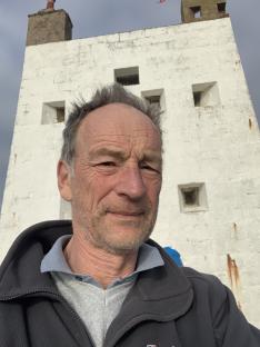 Man in front of a white castle.
