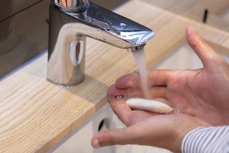 Close-up of a person washing their hands with soap.