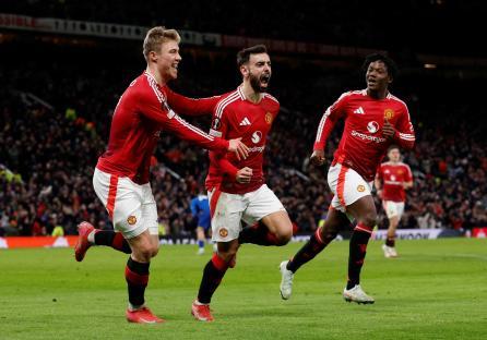 Manchester United players celebrating a goal.