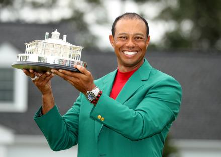 Tiger Woods holding the Masters Tournament trophy.