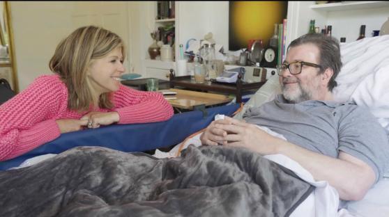 Kate Garraway and Derek Draper in a bedroom.