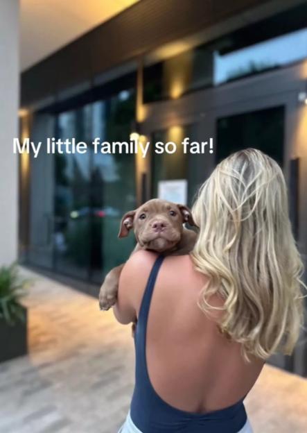 Woman holding a puppy.