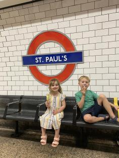 Two children eating ice cream at St. Paul's tube station.