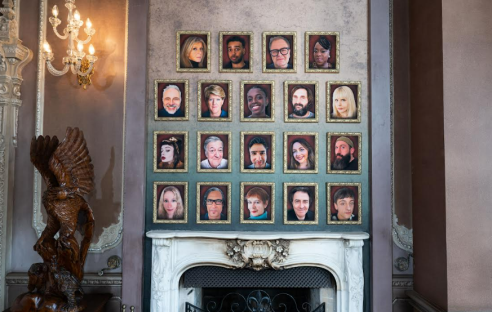 Wall of framed portraits of Celebrity Traitors 2025 contestants.