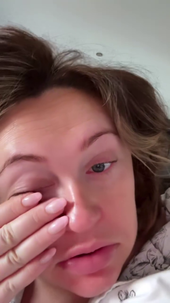 Close-up of a woman wiping her eye.