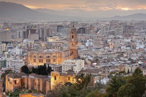 Malaga City, Spain, Europe. Malaga Cathedral and the walls of Alcazaba at dusk. Elevated view