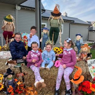 children sitting on a bale of hay with a sign that says fall blessings