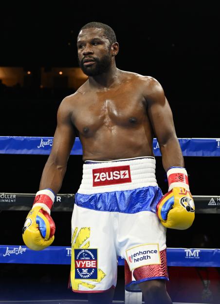 Floyd Mayweather Jr. stands in a boxing ring.