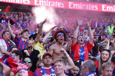 Crystal Palace fans celebrating at a soccer match.